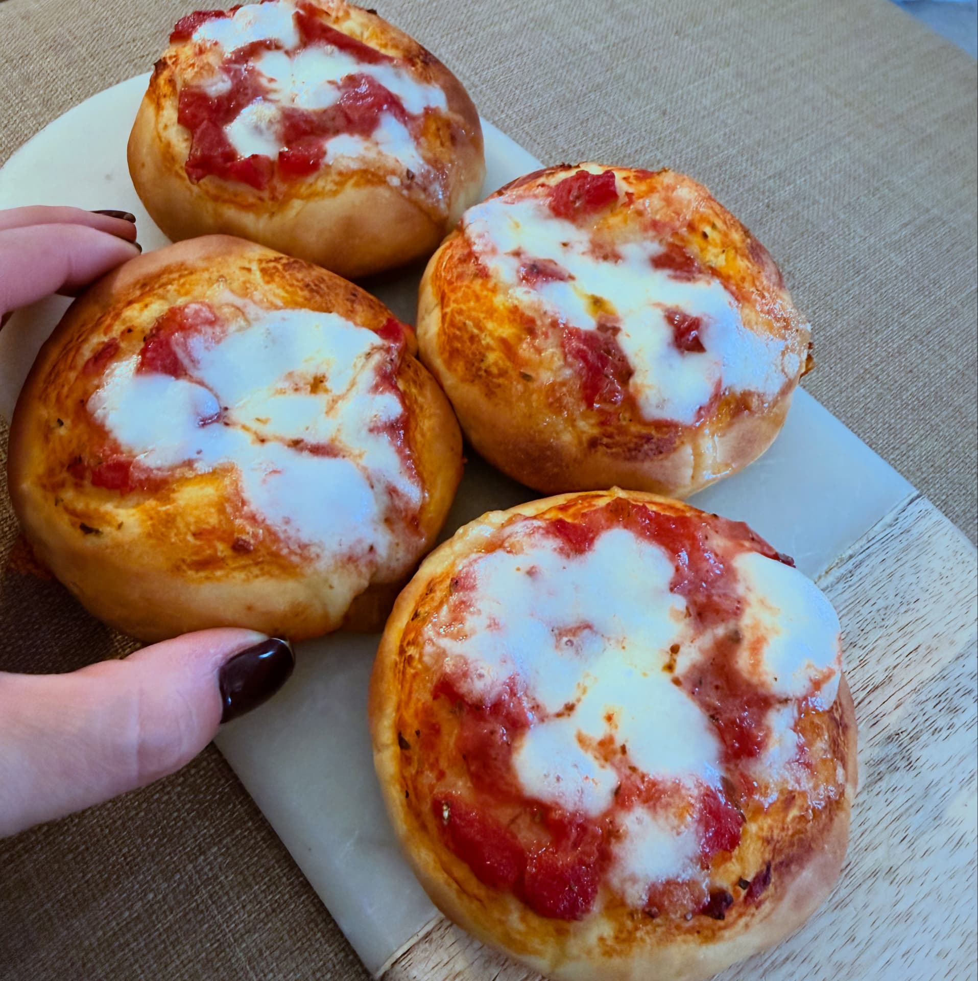 Four golden Sicilian pizzette with tomato and melted mozzarella
