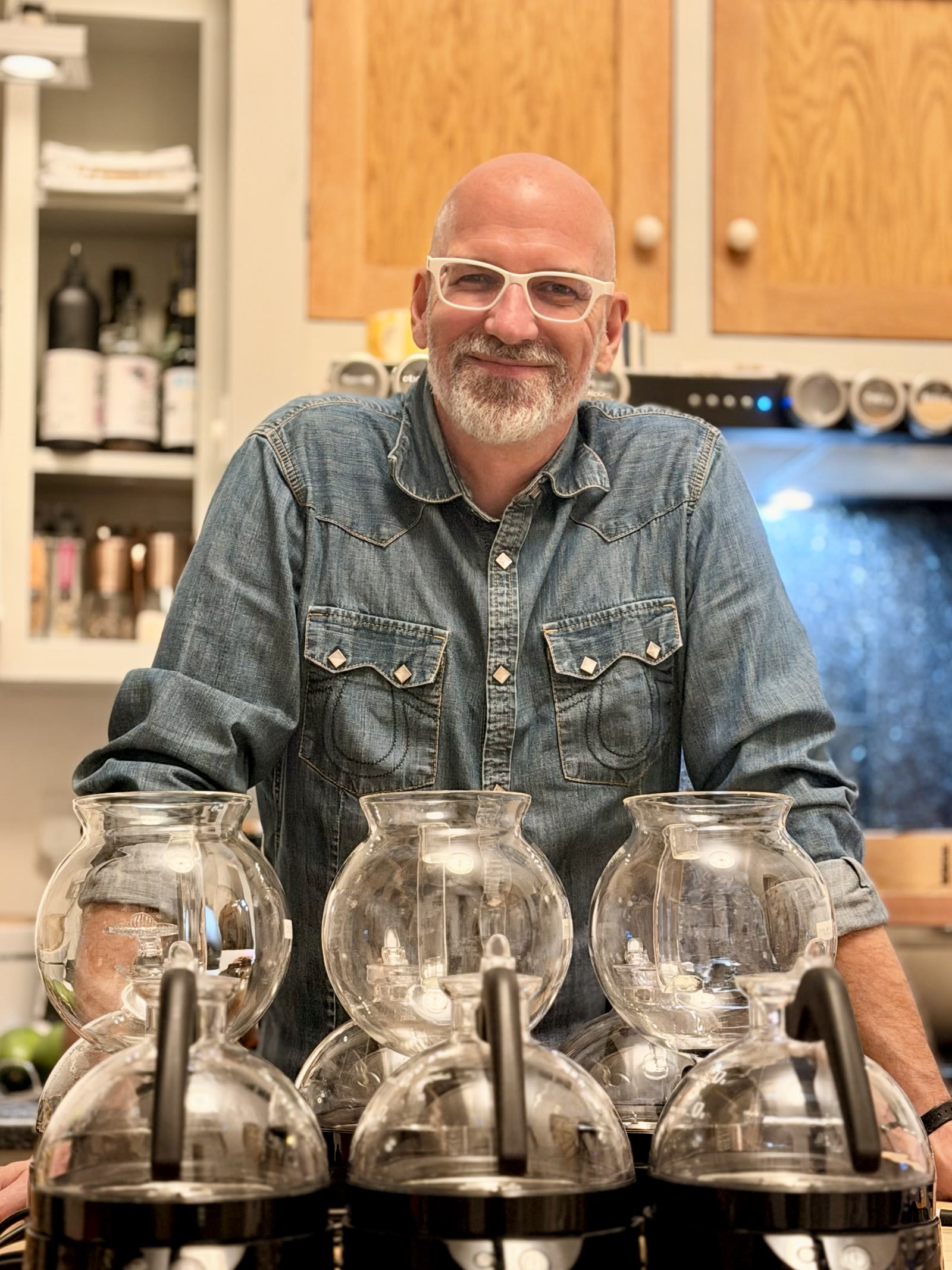 Dan behind his row of Bodum ePEBO vacuum brewers in our kitchen